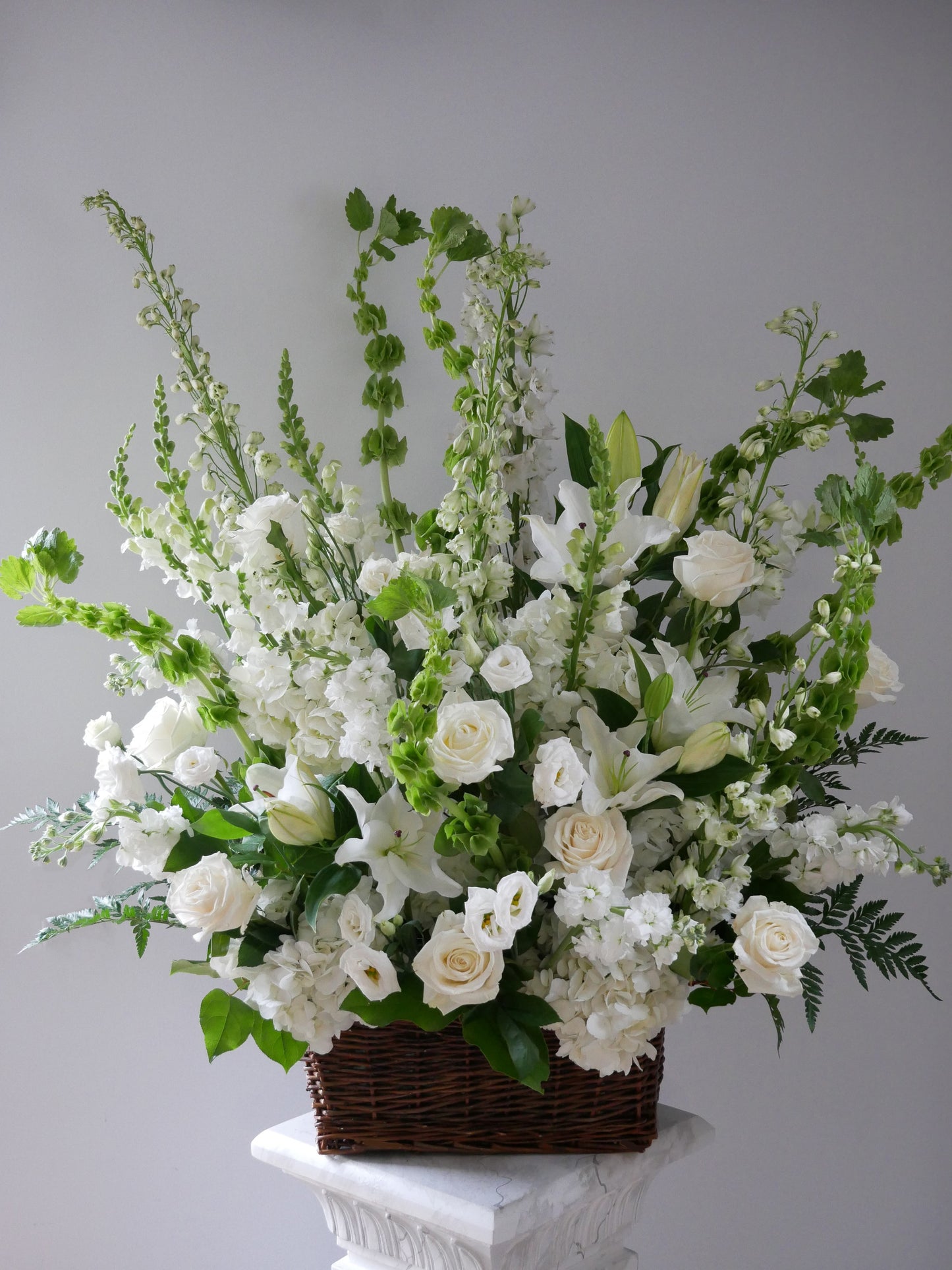 Funeral basket premium size featuring lilies, roses, hydrangeas, delphinium, lizianthus, and more by Floral Esthetics - Local Cape Cod Florist