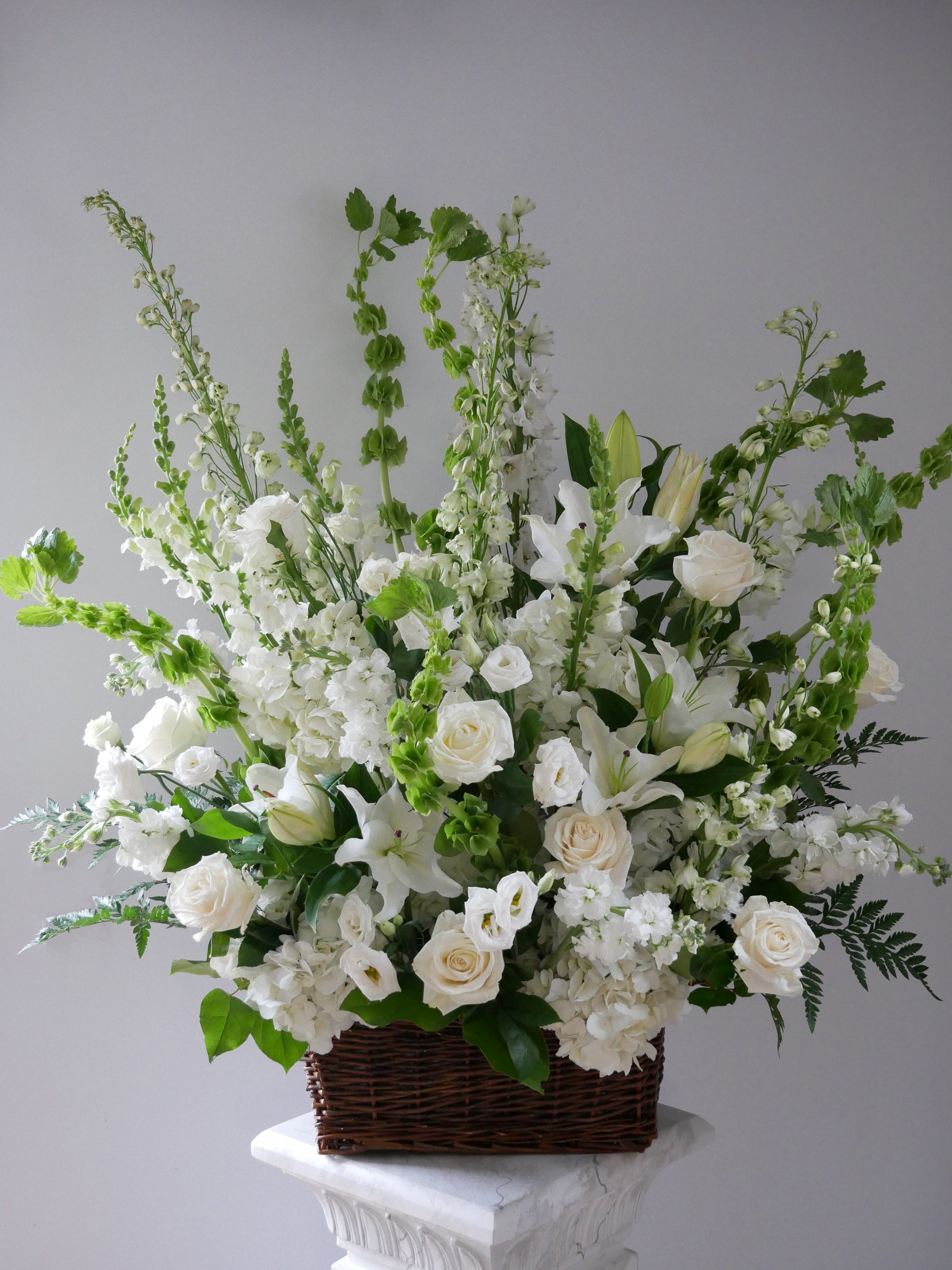 Funeral basket premium size featuring lilies, roses, hydrangeas, delphinium, lizianthus, and more by Floral Esthetics - Local Cape Cod Florist