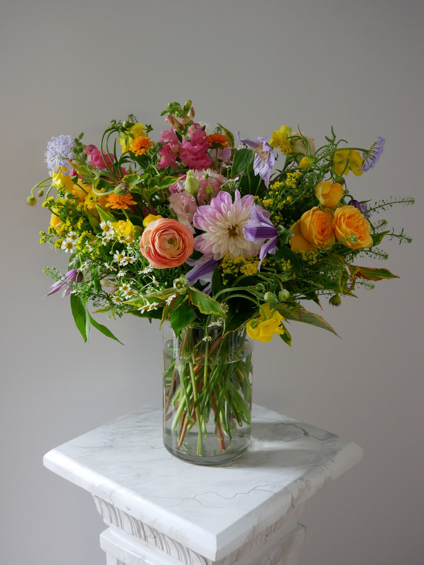 Garden-style premium flower arrangement  featuring dahlias, ranunculus, clematis, spray roses, camomiles and different greens by Floral Esthetics