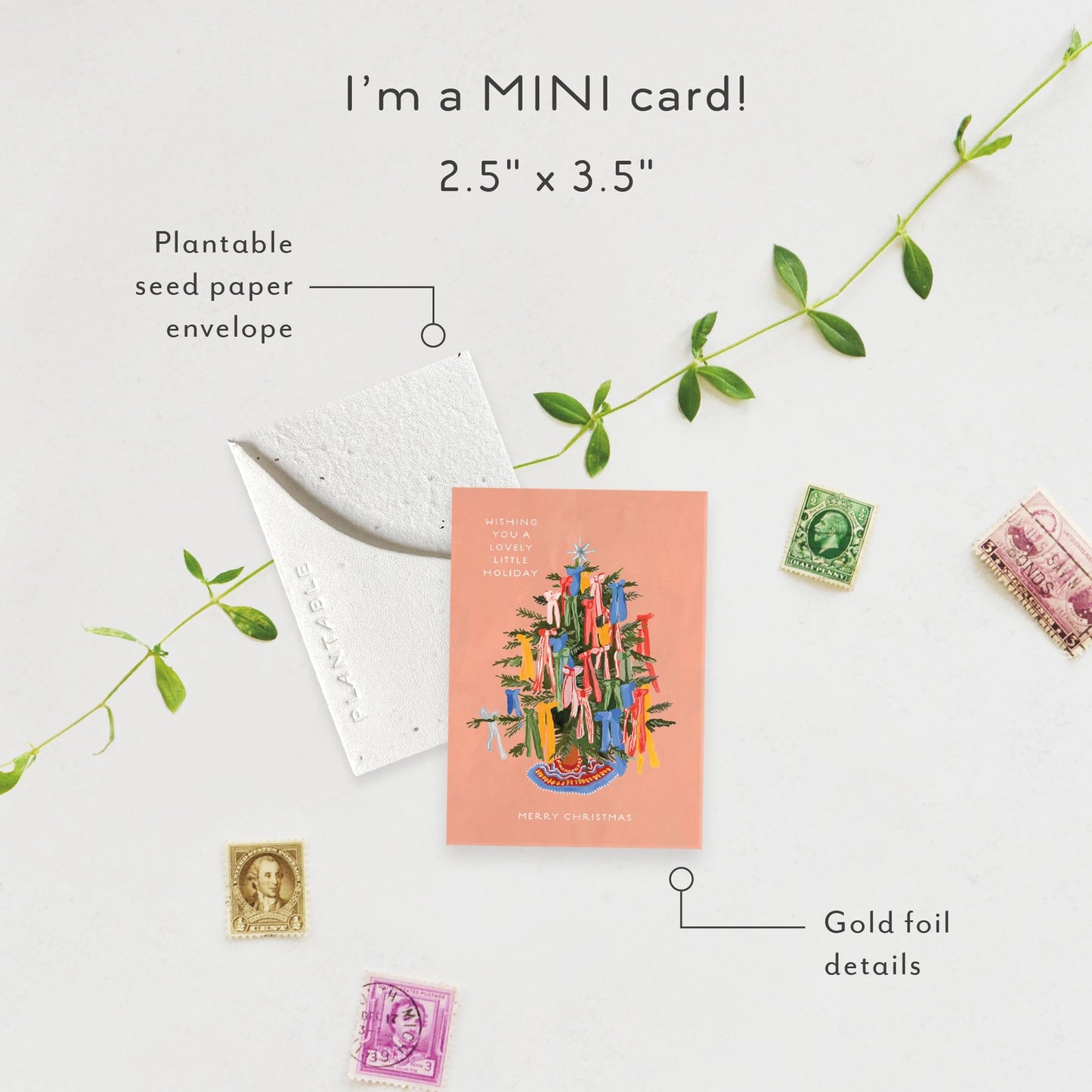 Miniature card with plantable seed paper envelope and gold foil details on a light background