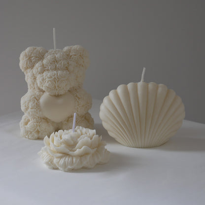 picture of 3 different shape candles include rose bear, shell and single rose