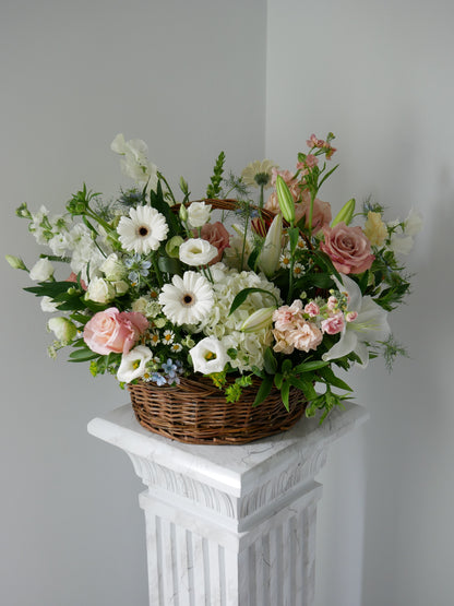 Large pastel color flower basket featuring hydrangea, gerberas, lilies, roses, lisianthus, stock and more 