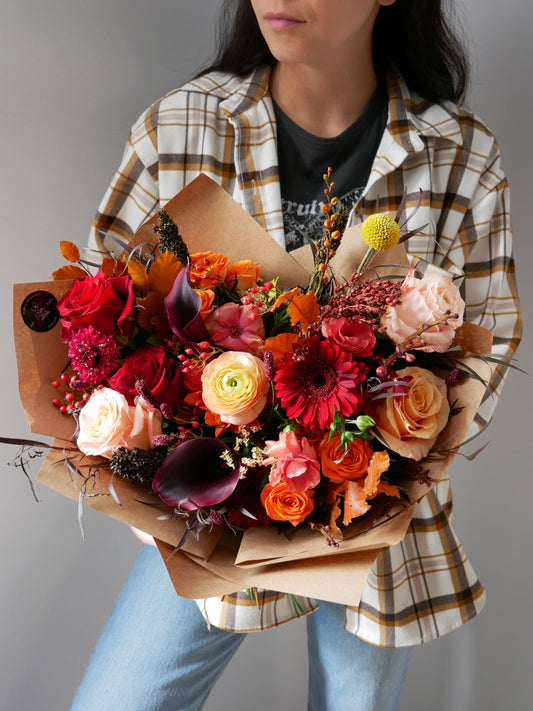 Premium fall bouquet featuring roses, gerberas, ranunkulus, calla lilies, seasonal blooms and berries by Floral Esthetics