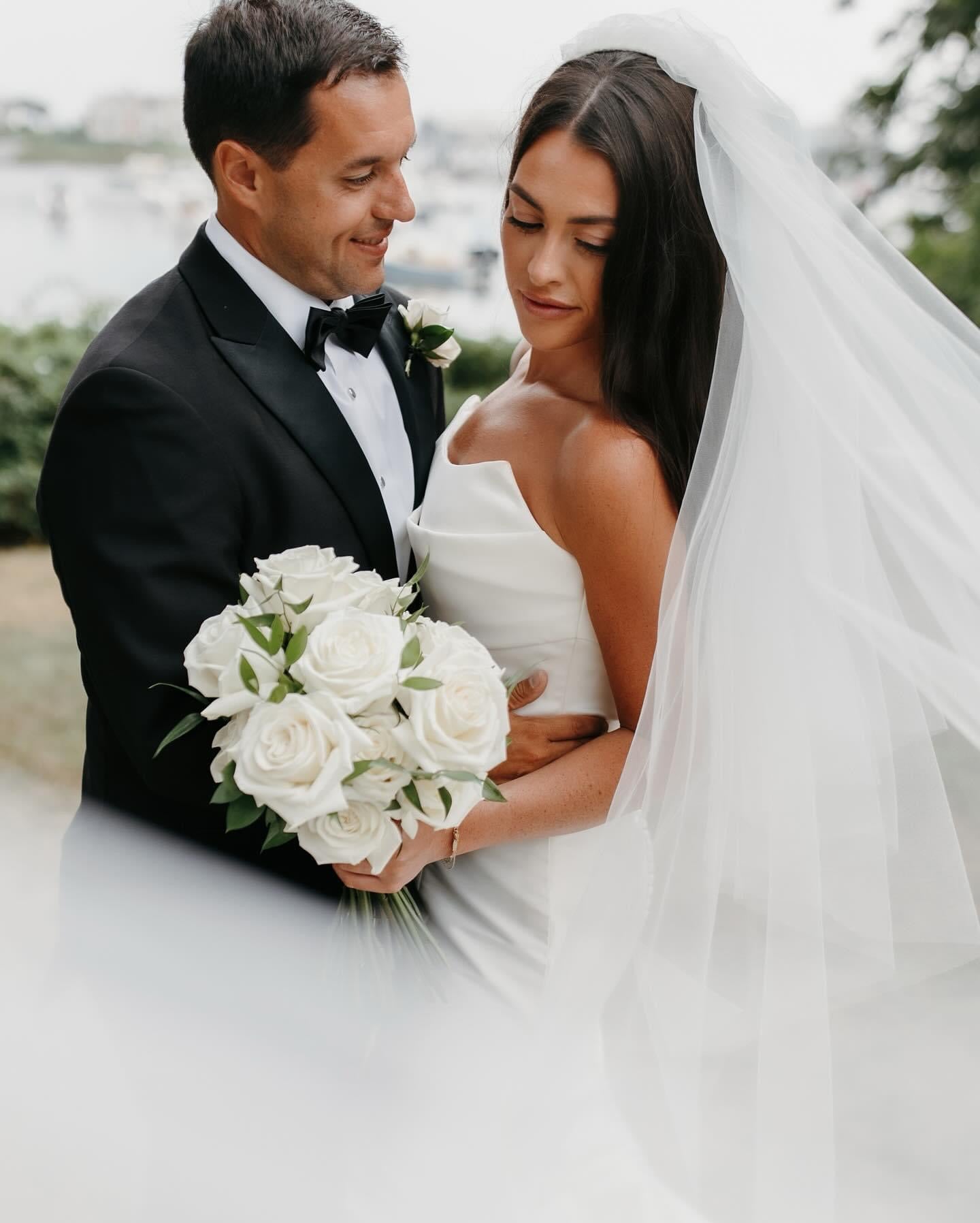 Bride and Groom holding a romantic floral bouquet by Floral Esthetics at Wychmere Beach Club