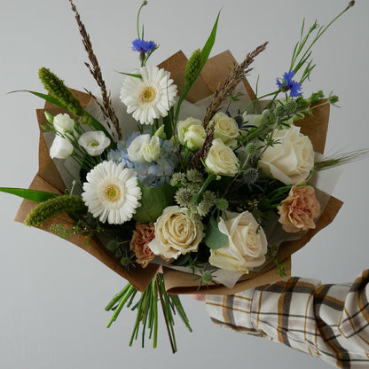 Standard size cape style wrapped bouquet featuring gerberas, roses, lizianthus and wild flowers by Floral Esthetics in Marstons Mills, MA