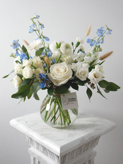 Standard size cape style flower arrangement in featuring ranunculus, delphinium, hydrangea, lizianthus, roses and other by Floral Esthetics - Cape Cod Florist