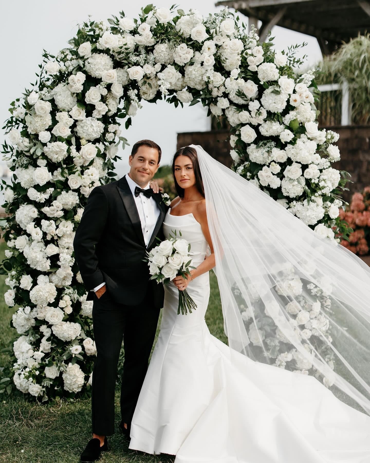 Floral arch of white hydrangeas, roses, lisianthus and greenery by Floral Esthetics at Wychmere Beach Club