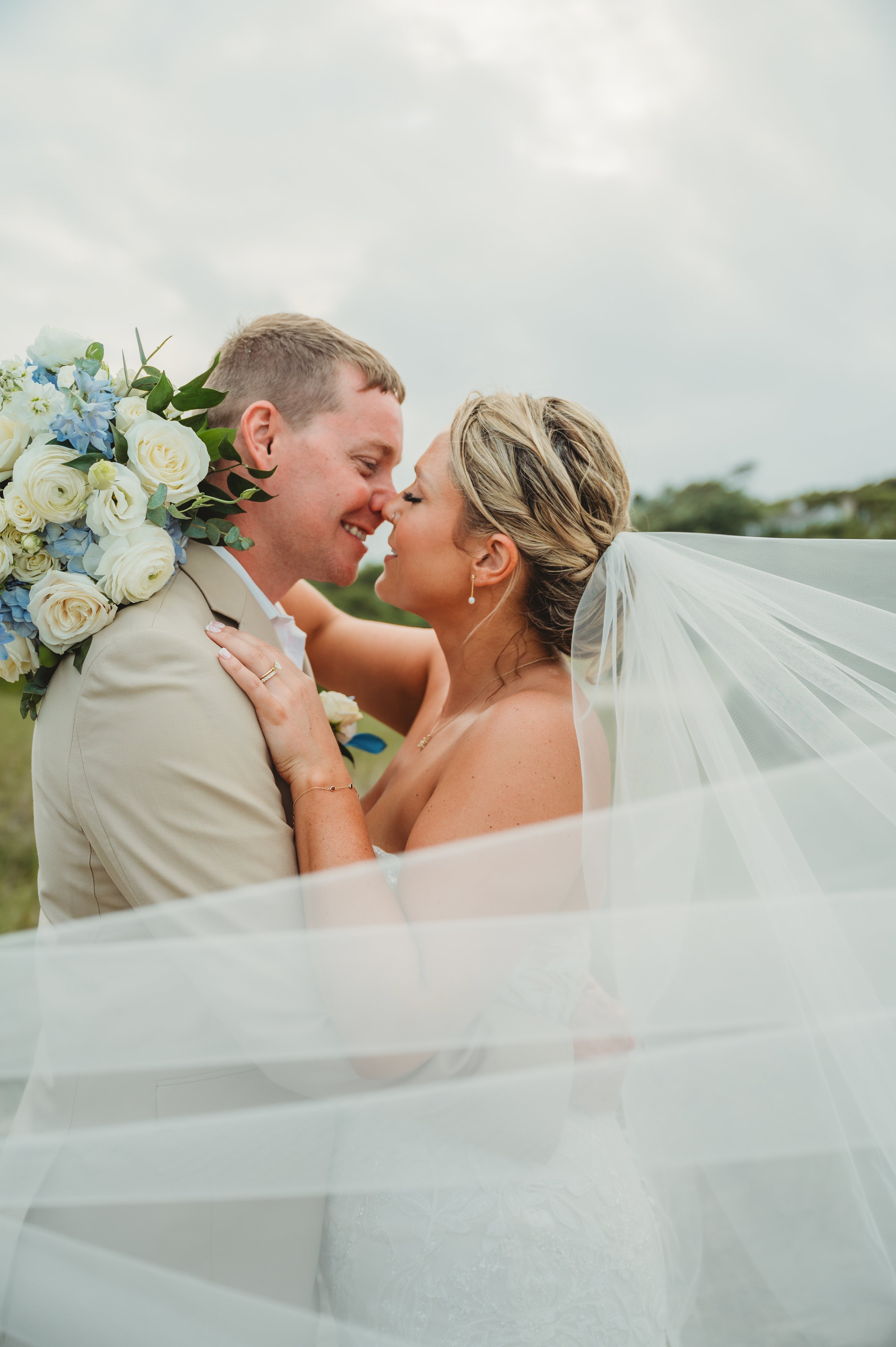 Bride and Groom holding a classic cape cod floral bouquet by Floral Esthetics at Wychmere Beach Club