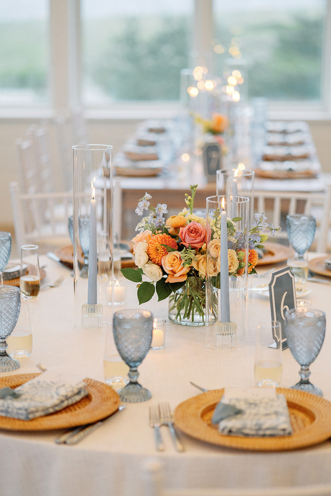 Colorful Cape Cod wedding table centerpiece with blue taper candles by Floral Esthetics at Wychmere Beach Club 