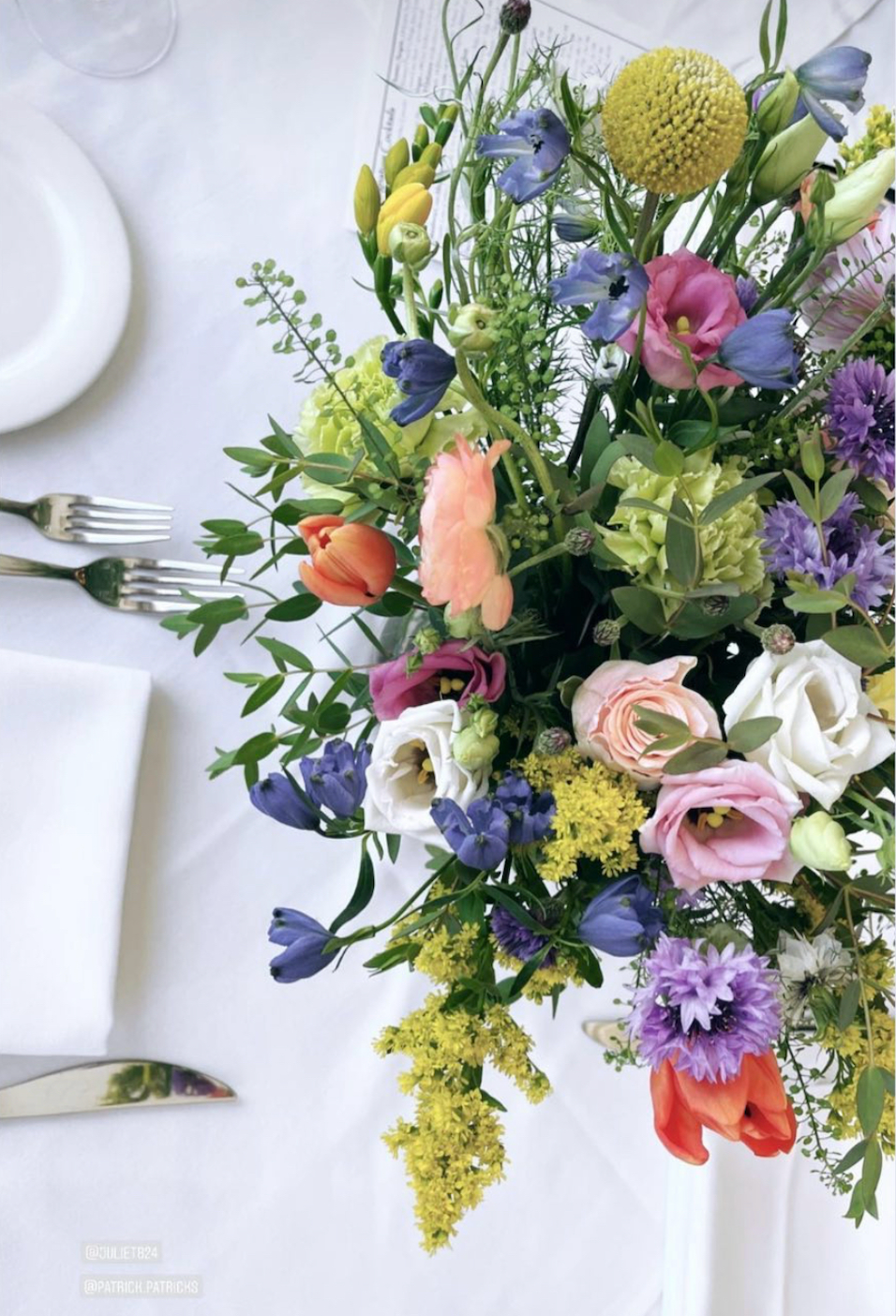 Detailed Cape Cod table centerpiece with wild flowers, ranunculus, tulips and more by Floral Esthetics