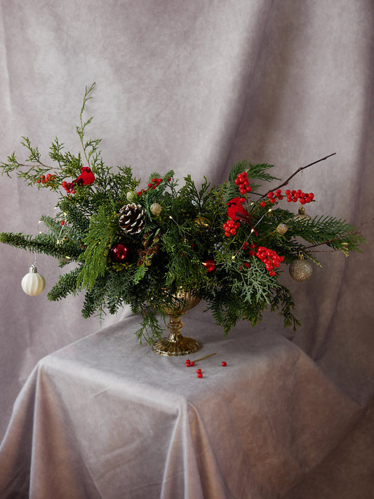 Christmas Centerpiece in Golden Compote with Lights, Christmas greens, berries and ornaments by Floral Esthetics