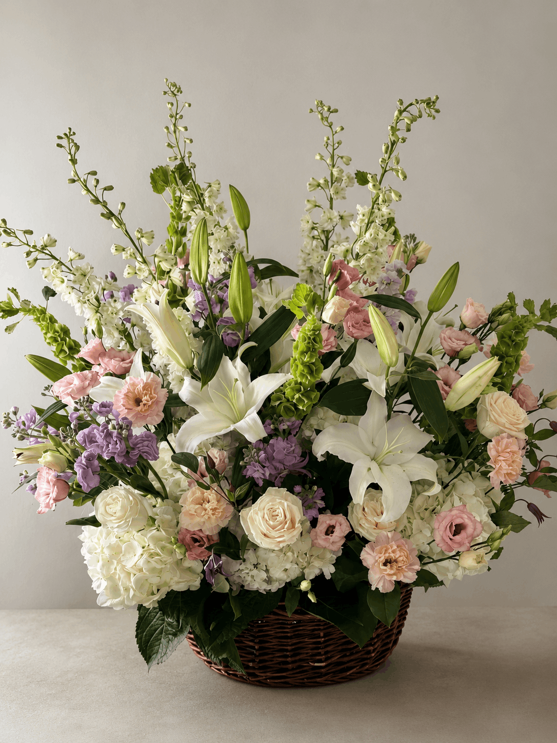 Bouquet of flowers in a basket on a neutral background