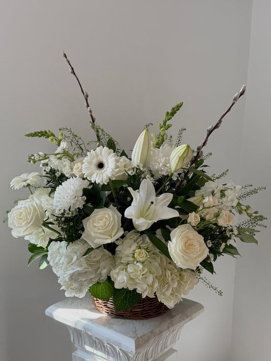 Sympathy flower basket in white color palette featuring lilies, hydrangeas, roses, chrysanthemum, gerberas and more  by Floral Esthetics