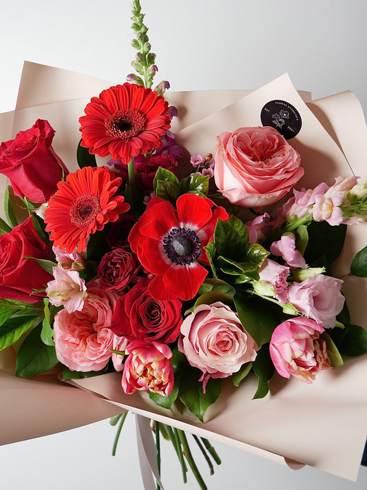 Valentine’s day special bouquet featuring anemone, gerberas, garden roses, tulips and greens