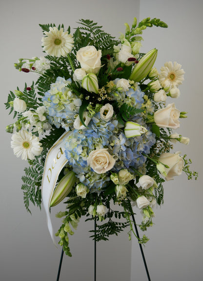 Funeral white and blue spray featuring hydrangea, roses, gerberas, lilies and other by Floral Esthetics