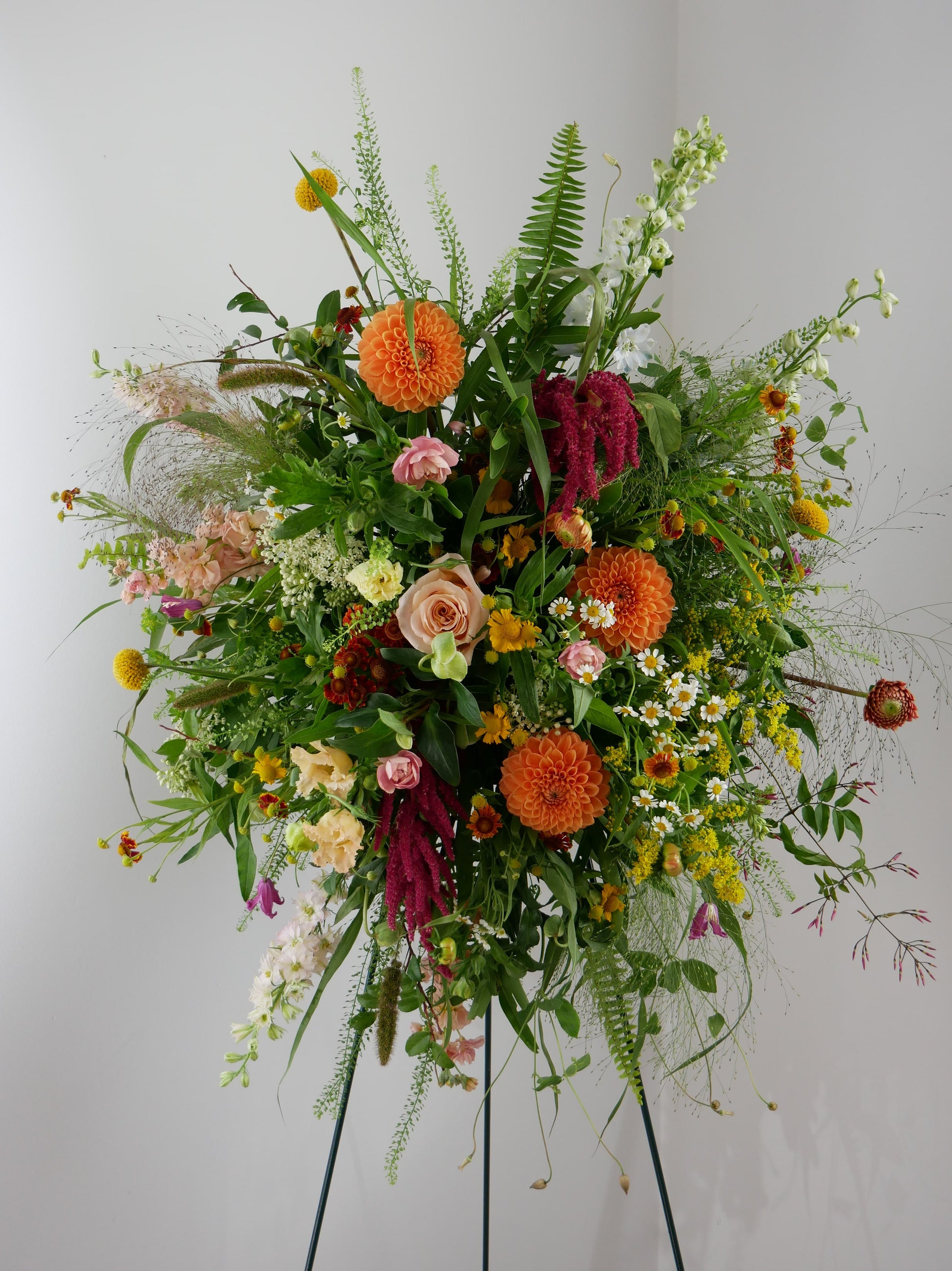 Funeral wild style spray featuring dahlias, amaranthus, camomiles and lots of wild greens by Floral Esthetics