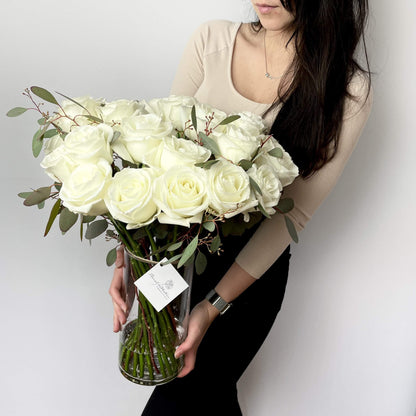 24 white roses in clear cylinder by Floral Esthetics