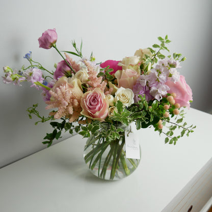 Premium colorful flower arrangement in clear vase
