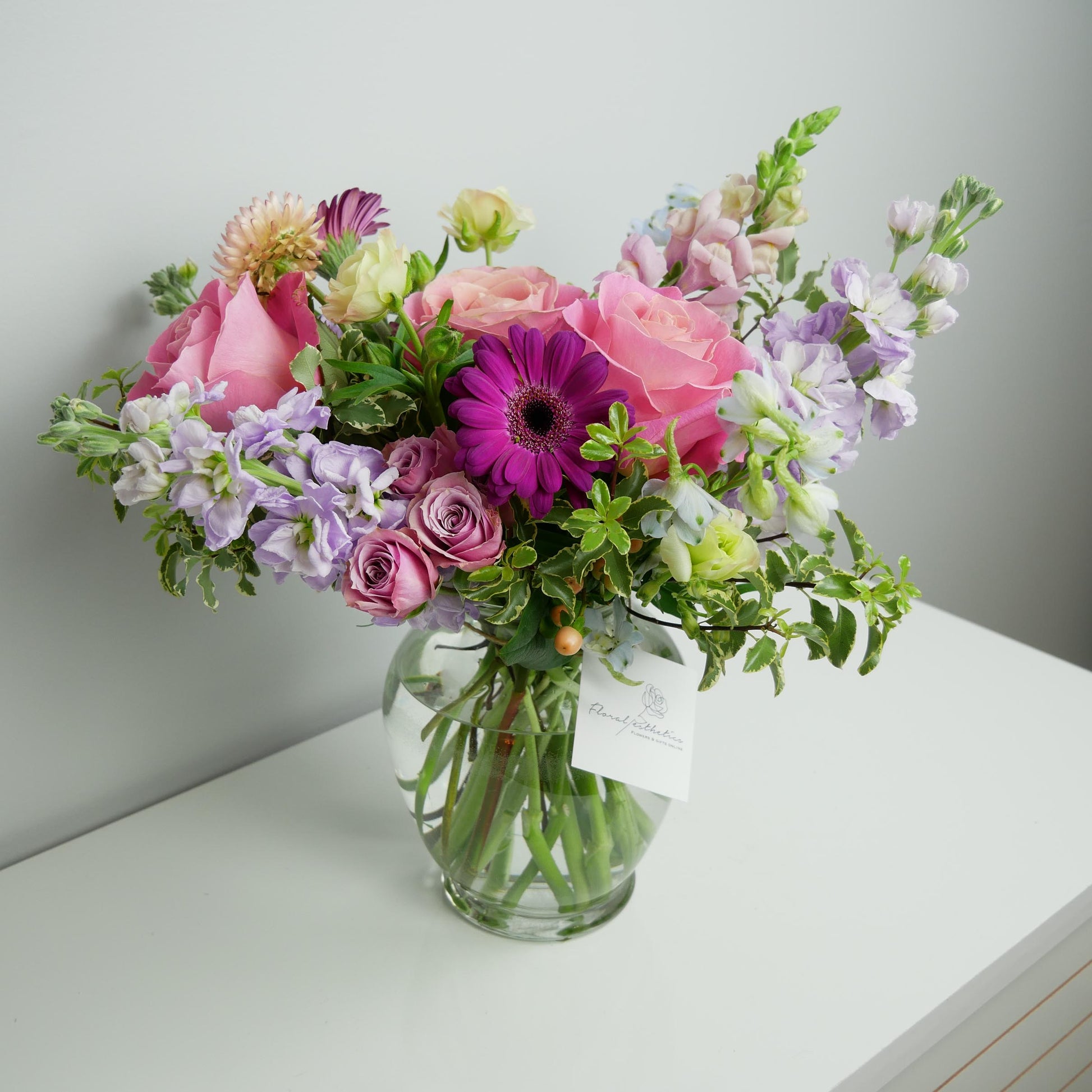 Standard size colorful flower arrangement in clear vase