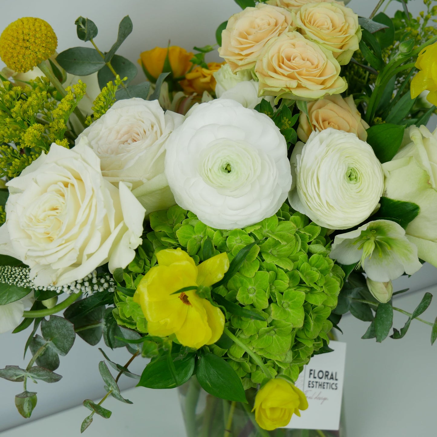 close-up on white and yellow flower arrangement by Floral Esthetics