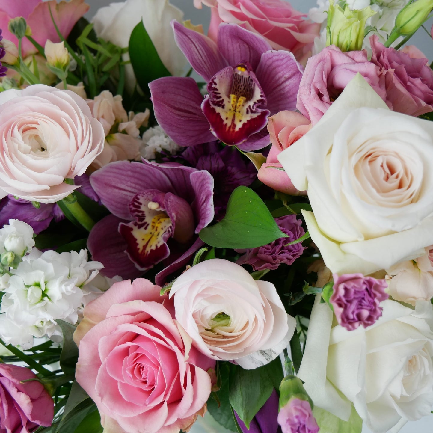 Close-up on Purple, white and pink premium size flower arrangement featuring orchids, ranunculus, roses, chrysanthemum and much more by Floral Esthetics